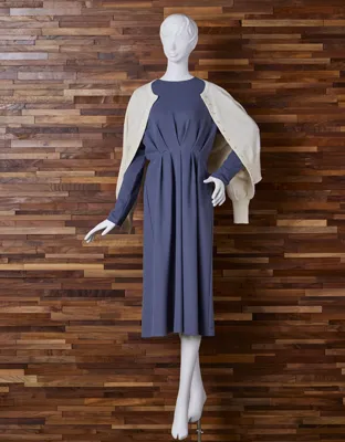 A one-piece dress with tucks from the bust to the waist that covers your torso.