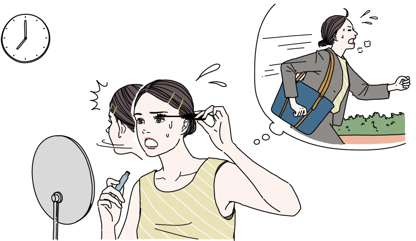 忙しい朝にメイクする女性